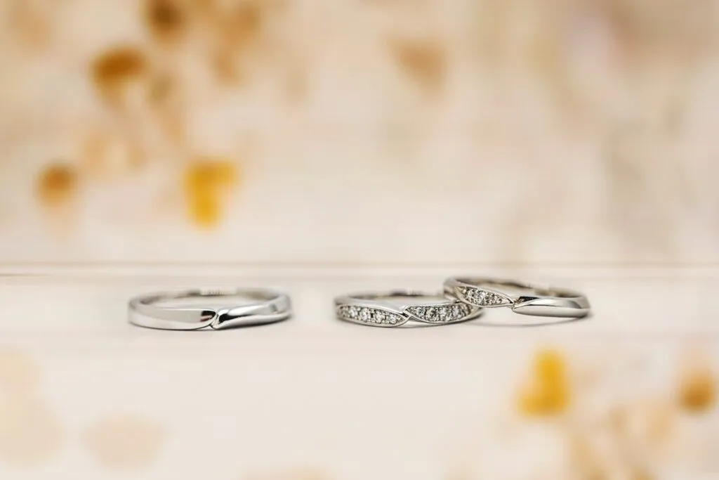 Three elegant silver rings with diamond accents.