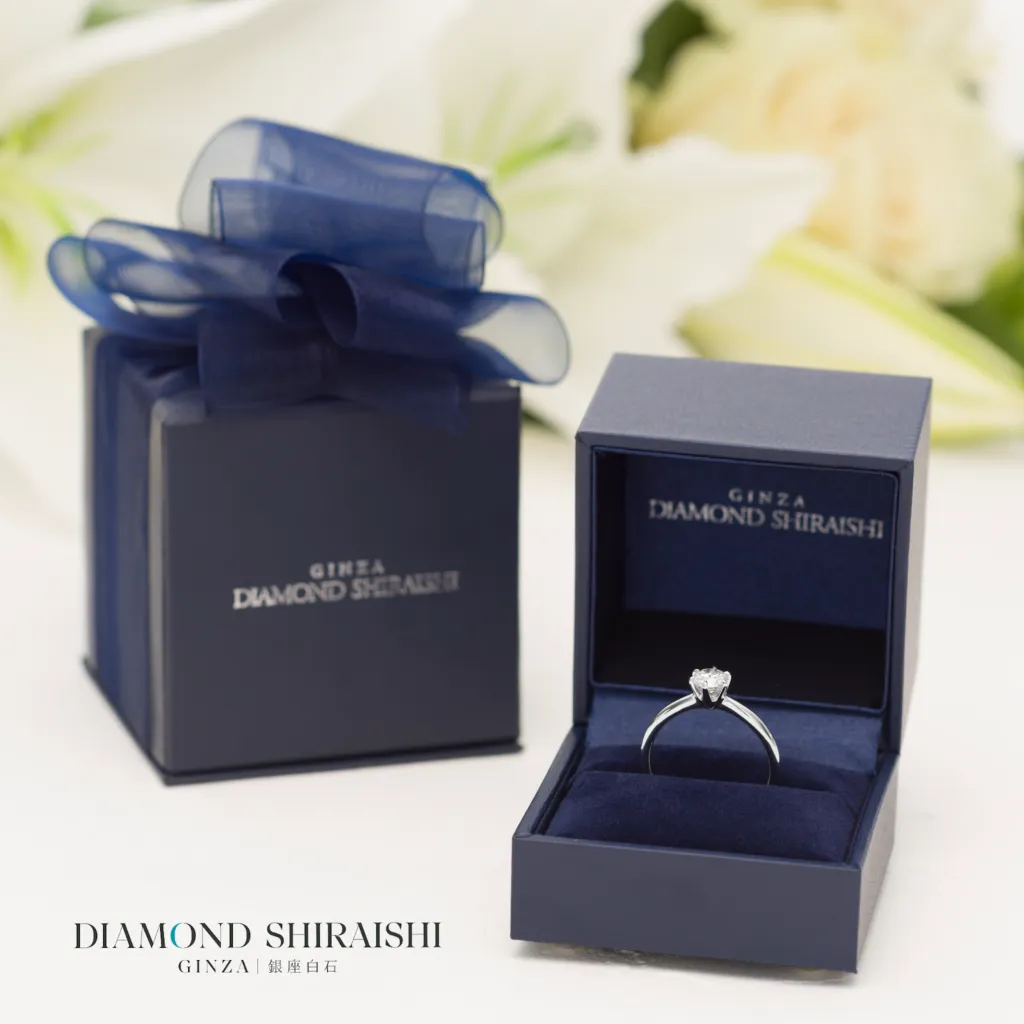 Elegant diamond ring in decorative gift box.