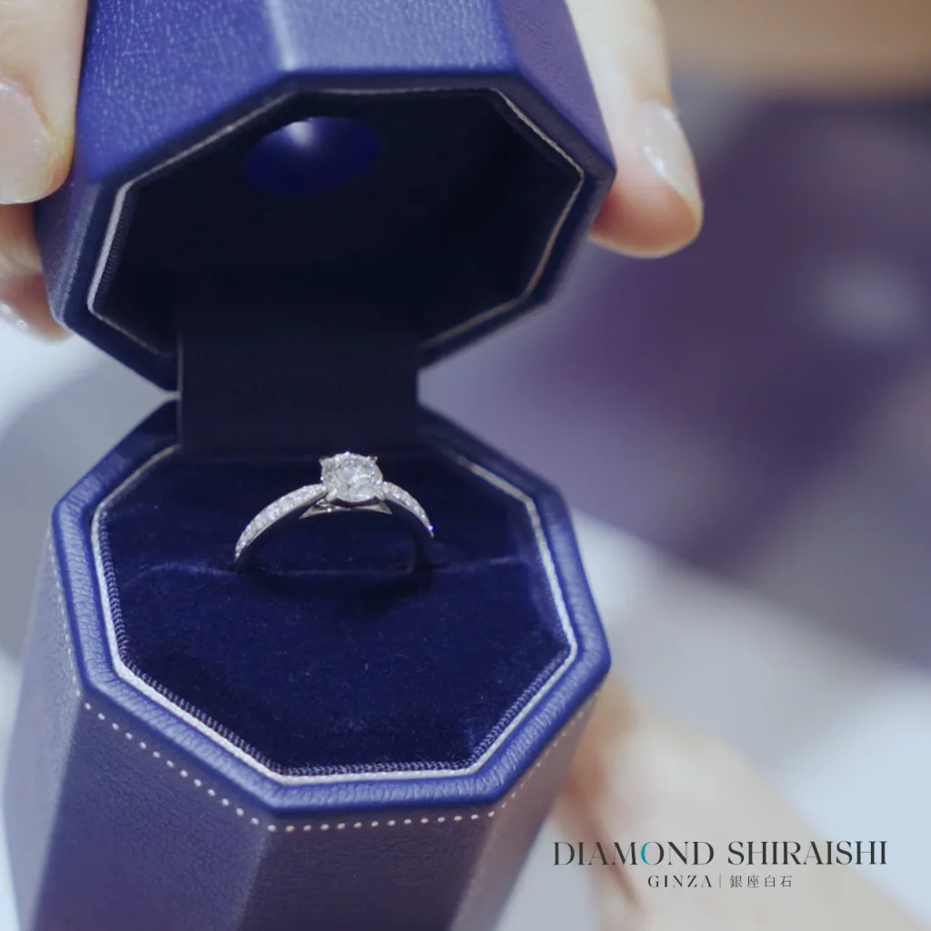 Elegant diamond ring in a blue velvet box.
